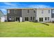 Townhome back exterior featuring a grassy yard and open patio at 1048 Winding Spring Dr, Mebane, NC 27302