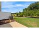 A home's backyard features lush green grass, partial fence and view of mature trees at 1048 Winding Spring Dr, Mebane, NC 27302