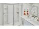 Bright bathroom featuring a glass-enclosed shower and double vanity at 1048 Winding Spring Dr, Mebane, NC 27302