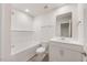 Bright bathroom with a tub, shower, white vanity and toilet with wood look flooring at 1048 Winding Spring Dr, Mebane, NC 27302