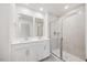 The bathroom features double sinks, modern vanities, large mirrors and a glass shower at 1048 Winding Spring Dr, Mebane, NC 27302