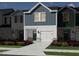 Rendering of new townhome showing modern designs, attached garages, and colorful landscaping at 1048 Winding Spring Dr, Mebane, NC 27302