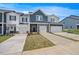 New townhome with a classic painted facade, attached garage and inviting curb appeal at 1048 Winding Spring Dr, Mebane, NC 27302