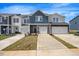 New townhomes feature modern exteriors with attached garages and freshly laid sod at 1048 Winding Spring Dr, Mebane, NC 27302