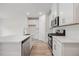 Modern kitchen featuring stone countertops, stainless steel appliances, and wood-look flooring at 1048 Winding Spring Dr, Mebane, NC 27302