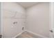 The laundry room has wood look flooring with hookups and a metal shelf at 1048 Winding Spring Dr, Mebane, NC 27302