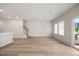 Open-concept living room featuring hardwood floors, recessed lighting, and a sliding door to the outside at 1048 Winding Spring Dr, Mebane, NC 27302