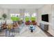 Bright living room with stylish decor, large windows, and comfortable seating area at 1048 Winding Spring Dr, Mebane, NC 27302
