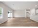 A spacious living room featuring hardwood floors and an open-concept layout connected to the kitchen at 1048 Winding Spring Dr, Mebane, NC 27302