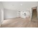 Open living space featuring hardwood floors, neutral colors, and an open plan to the kitchen at 1048 Winding Spring Dr, Mebane, NC 27302