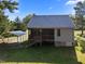 Exterior view of a house, showcasing the metal roof, rear porch, and backyard at 108 Ruff Davis Rd, Roxboro, NC 27574