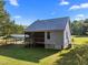 Rear exterior of a house with grey siding and a metal roof; a covered carport is visible at 108 Ruff Davis Rd, Roxboro, NC 27574