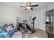 Bedroom with a ceiling fan, exercise equipment and door leading to the outside at 108 Ruff Davis Rd, Roxboro, NC 27574