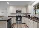 Efficient kitchen featuring stainless steel appliances, granite countertops, and a functional layout, ideal for cooking and entertaining at 108 Ruff Davis Rd, Roxboro, NC 27574