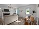 Open-concept living area with a dining table, comfortable seating, and natural light, perfect for modern living and entertaining at 108 Ruff Davis Rd, Roxboro, NC 27574