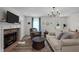 Inviting living room with a stone fireplace, plush seating, and a view of the front door, radiating warmth and comfort at 108 Ruff Davis Rd, Roxboro, NC 27574