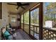 Covered porch with a ceiling fan and railing overlooking a big yard at 108 Ruff Davis Rd, Roxboro, NC 27574