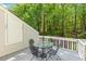 Back deck features umbrella table and overlooks lush yard and woods at 108 Woodglen Dr, Cary, NC 27518