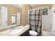 Bathroom includes a vanity with granite countertop, a shower/tub combo with patterned curtain at 108 Woodglen Dr, Cary, NC 27518