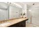 Bathroom featuring double sinks, granite countertop, and a glass-enclosed shower at 108 Woodglen Dr, Cary, NC 27518