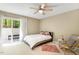 Cozy bedroom featuring a ceiling fan and a sliding glass door that leads to a deck at 108 Woodglen Dr, Cary, NC 27518