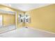 Bedroom with bright yellow walls, sliding mirror closet, and double windows at 108 Woodglen Dr, Cary, NC 27518