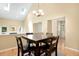 Bright dining room featuring a square dining table, stylish chandelier, and lots of natural light from skylights at 108 Woodglen Dr, Cary, NC 27518