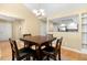 Dining area with natural light, view into the kitchen and wood floors at 108 Woodglen Dr, Cary, NC 27518