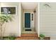 Inviting entryway with a brick step and dark-green front door at 108 Woodglen Dr, Cary, NC 27518