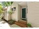 Inviting home entryway featuring a green front door and brick steps at 108 Woodglen Dr, Cary, NC 27518