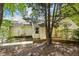 Home exterior featuring brick detail and mature trees at 108 Woodglen Dr, Cary, NC 27518
