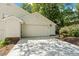 Attached garage with ample driveway space and manicured landscaping at 108 Woodglen Dr, Cary, NC 27518