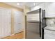 Stainless steel refrigerator with white cabinetry and view of closet at 108 Woodglen Dr, Cary, NC 27518