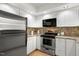 Kitchen features stainless steel appliances, white cabinets, and backsplash at 108 Woodglen Dr, Cary, NC 27518