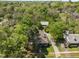 Aerial view of property featuring a house with mature trees, landscaping, and outbuilding at 109 N Hassel St, Hillsborough, NC 27278