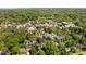 This aerial view displays the town center surrounded by mature trees and featuring a variety of local shops at 109 N Hassel St, Hillsborough, NC 27278