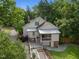 Aerial view of a charming home with a screened porch, stone patio, and beautifully landscaped yard at 109 N Hassel St, Hillsborough, NC 27278