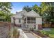 Inviting backyard featuring a screened porch, stone patio, and meticulously maintained garden beds at 109 N Hassel St, Hillsborough, NC 27278