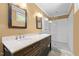 Bathroom featuring double vanity with marble countertop and walk-in shower with white subway tile at 109 N Hassel St, Hillsborough, NC 27278