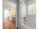 A bathroom with a white subway tile, window, bathtub with shower, and an ensuite bathroom at 109 N Hassel St, Hillsborough, NC 27278