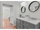 A stylish bathroom featuring double vanity, framed mirrors, and marble countertops at 109 N Hassel St, Hillsborough, NC 27278