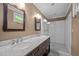 Bathroom featuring double vanity with marble countertops and a glass enclosed shower at 109 N Hassel St, Hillsborough, NC 27278
