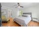 A bright bedroom with hardwood floors, ceiling fan, and ensuite bathroom access at 109 N Hassel St, Hillsborough, NC 27278