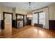 Elegant dining room features hardwood floors, decorative fireplace, and a stunning chandelier at 109 N Hassel St, Hillsborough, NC 27278