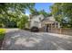 Long driveway leads to a charming home with a well-manicured yard and pergola at 109 N Hassel St, Hillsborough, NC 27278