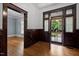 Detailed woodwork and original hardwood floors highlight the entryway at 109 N Hassel St, Hillsborough, NC 27278