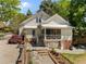 Exterior of a charming home with a screened porch, patio, and beautifully landscaped yard at 109 N Hassel St, Hillsborough, NC 27278