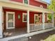 Cozy covered porch featuring decorative railings and views of the landscaped yard at 109 N Hassel St, Hillsborough, NC 27278