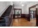 Grand foyer with original wood trim, staircase, and hardwood floors at 109 N Hassel St, Hillsborough, NC 27278
