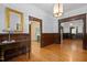 Elegant foyer showcasing dark woodwork, hardwood floors, and arched doorways at 109 N Hassel St, Hillsborough, NC 27278